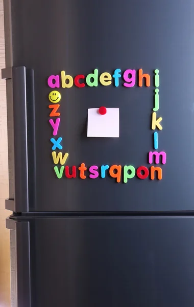 Colorful magnetic letters on refrigerator — Stock Photo, Image