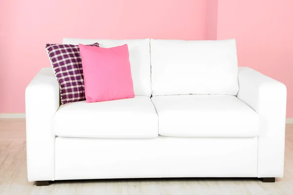 White sofa in room on pink background — Stock Photo, Image