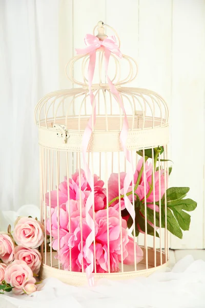 Beautiful decorative cage with beautiful flowers — Stock Photo, Image