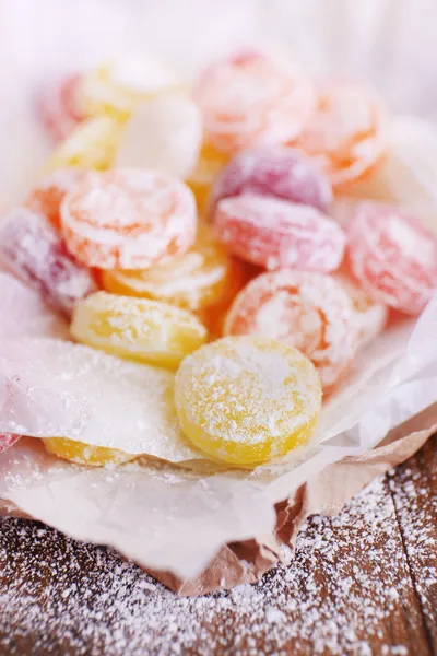 Sweet multicolor candies on paper, close up — Stock Photo, Image