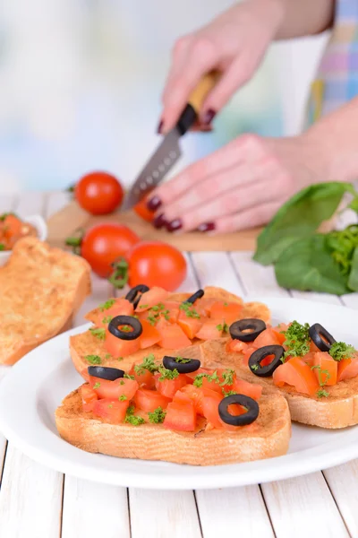 Delicious bruschetta with tomatoes on plate on table close-up — Stock Photo, Image