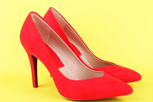 Beautiful red female shoes, on yellow background — Stock Photo, Image