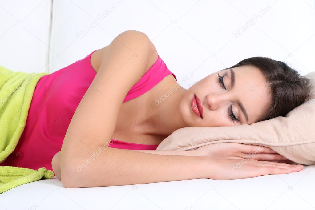 Beautiful young woman sleeping on sofa close up