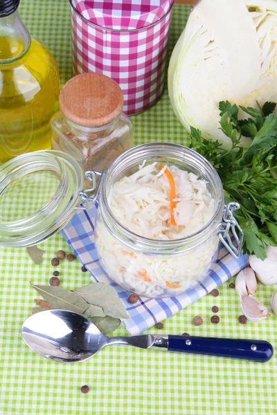 Composition with fresh and marinated cabbage (sauerkraut), spices, on wooden table, on color napkin background — Stock Photo, Image