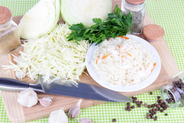 Composition with fresh and marinated cabbage (sauerkraut), spices, on color napkin background — Stock Photo, Image