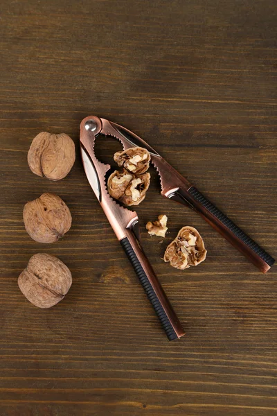 Nutcracker and walnuts isolated on white background — Stock Photo, Image