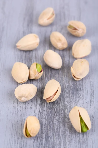 Pistachio nuts on wooden background — Stock Photo, Image