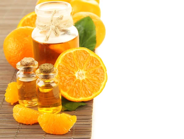 Tangerine essential oil and tangerines, isolated on white — Stock Photo, Image