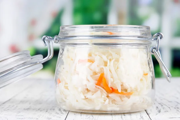 Marinated cabbage (sauerkraut) in glass jar, on wooden background — Stock Image Marinated cabbage (sauerkraut) in glass jar, on wooden background Stock Photo