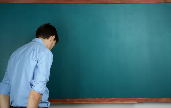 学校の教室で黒板の近くの若い教師 — ストック写真