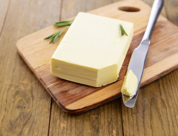 Tasty butter on wooden cutting board — Stock Photo, Image