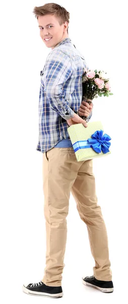 Schöner junger Mann mit Blumen und Geschenk, isoliert auf weiß — Stockfoto