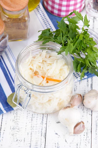 Composition with fresh and marinated cabbage (sauerkraut), spices, on wooden table background — Stock Photo, Image