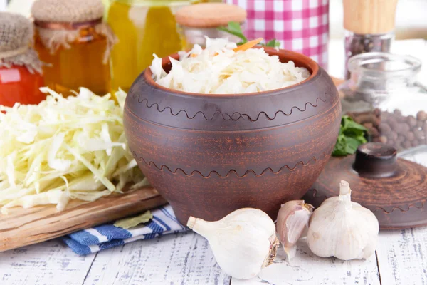 Composition with fresh and marinated cabbage (sauerkraut), spices, on wooden table background — Stock Photo, Image