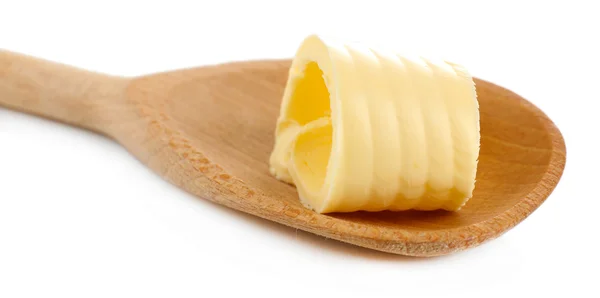 Rotatie van verse boter op houten lepel, geïsoleerd op wit — Stockfoto