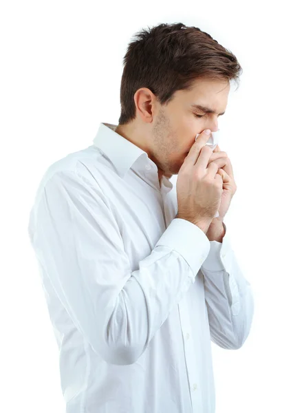 Sneezing young man isolated on white — Stock Photo, Image