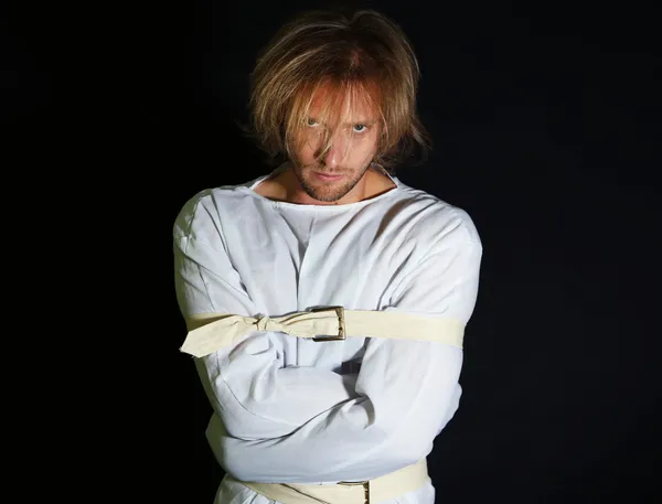 Mentally ill man in strait-jacket on black background — Stock Photo, Image