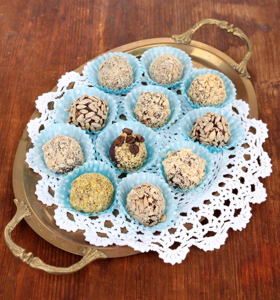 Set of chocolate candies, on tray, on wooden background — Stock Photo, Image