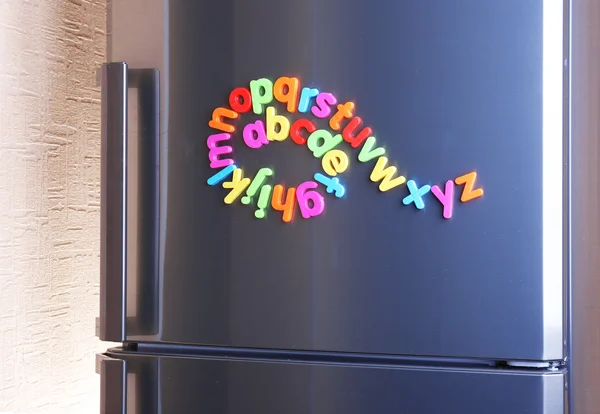 Colorful magnetic letters on refrigerator — Stock Photo, Image