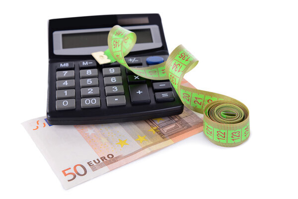 Tape measure with money and calculator isolated on white