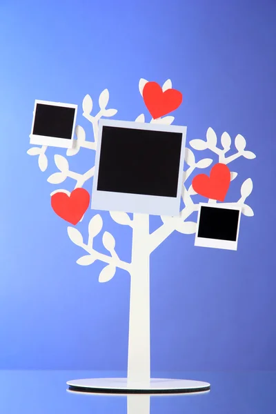 Holder in form of tree with instant photo cards on dark color background — Stock Photo, Image