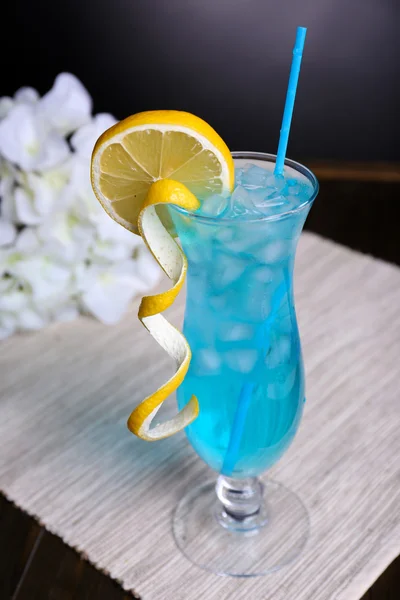 Glass of cocktail on table on grey background — Stock Photo, Image