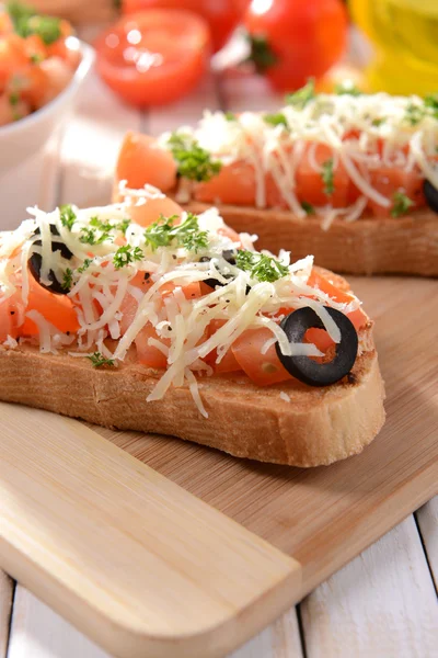 Deliziosa bruschetta con pomodori sul tagliere primo piano — Foto Stock