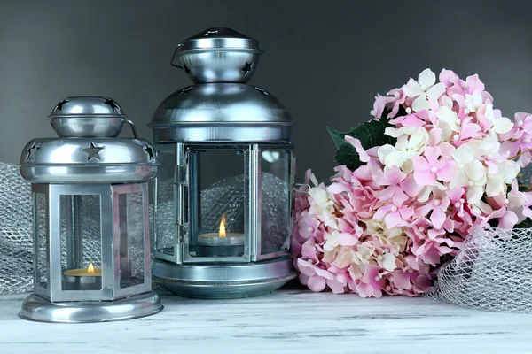 Decorative metallic lantern on wooden table on grey background — Stock Photo, Image