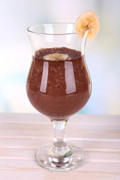 Cocktail with banana and chocolate on table on light background — Stock Photo, Image