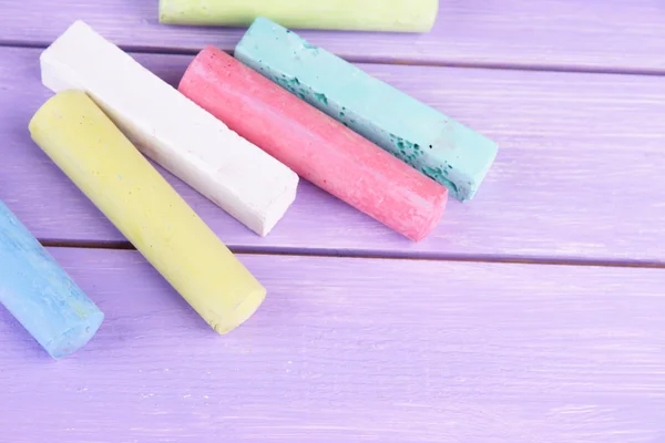 Chalks in variety of colors, on wooden background — Stock Photo, Image