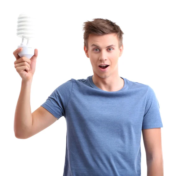 Joven con lámpara de ahorro de energía, aislado en blanco — Foto de Stock