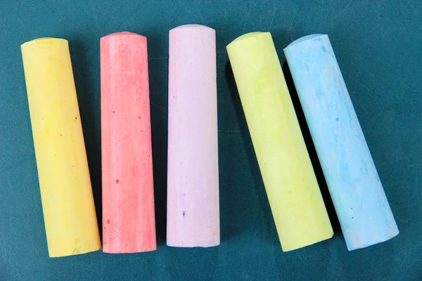 Colorful chalks on school desk — Stock Photo, Image