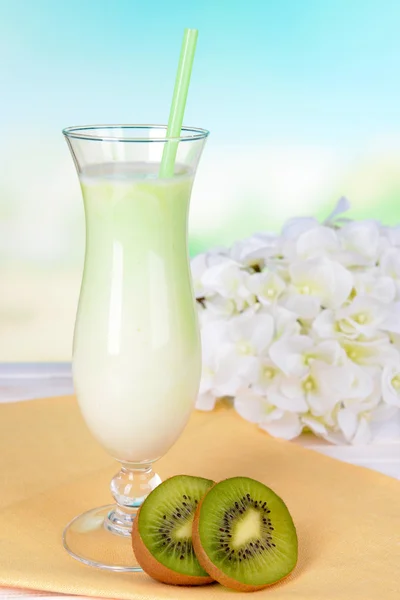 Batido de leite na mesa no fundo azul claro — Fotografia de Stock