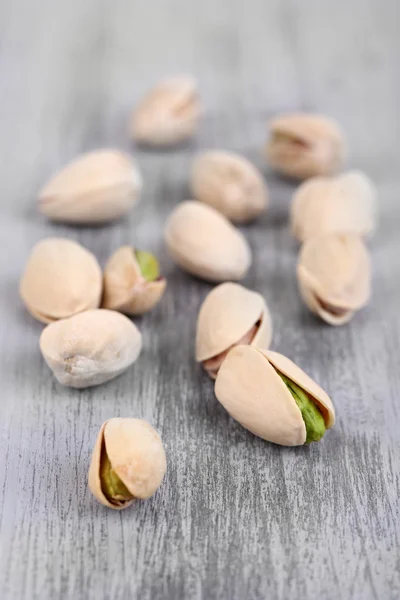 Pistachio nuts on wooden background — Stock Photo, Image