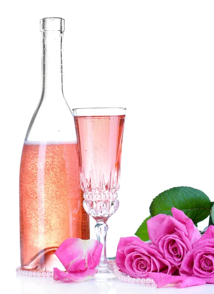 Composition with pink sparkle wine in glass, bottle and pink roses isolated on white — Stock Photo, Image