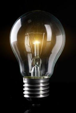 Light bulb on dark background clipart