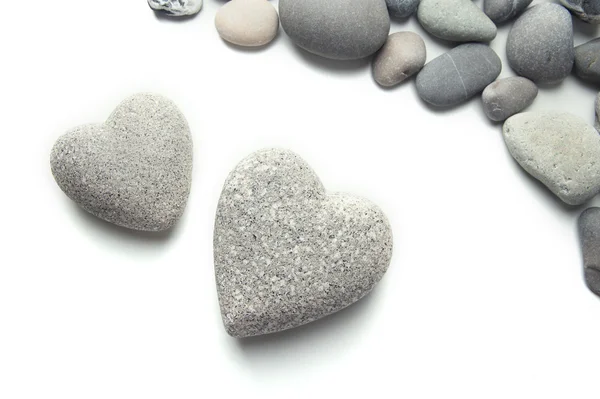 Piedras grises en forma de corazón, aisladas en blanco — Foto de Stock