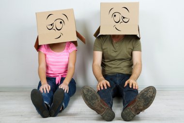 karton kutular üzerinde başlarını duvara yakın katta oturan Çift