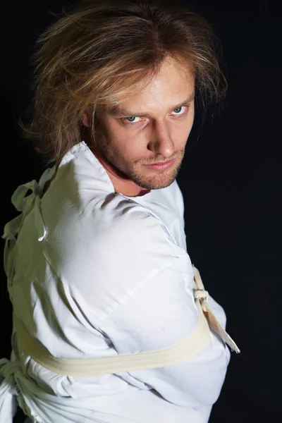 Mentally ill man in strait-jacket on black background — Stock Photo, Image