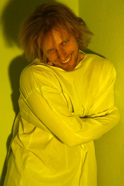 Mentally ill man in strait-jacket in room corner — Stock Photo, Image