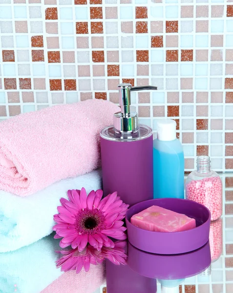 Cosmetics and bath accessories on mosaic tiles background — Stock Photo, Image