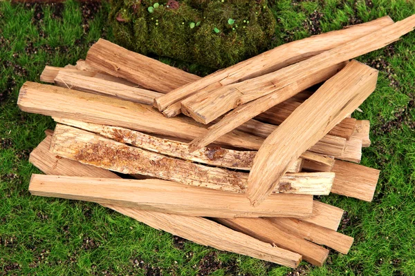 Stack of firewood on grass close up — Stock Photo, Image