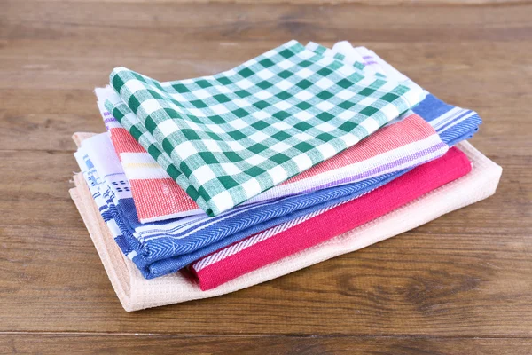Kitchen towels on wooden background — Stock Photo, Image