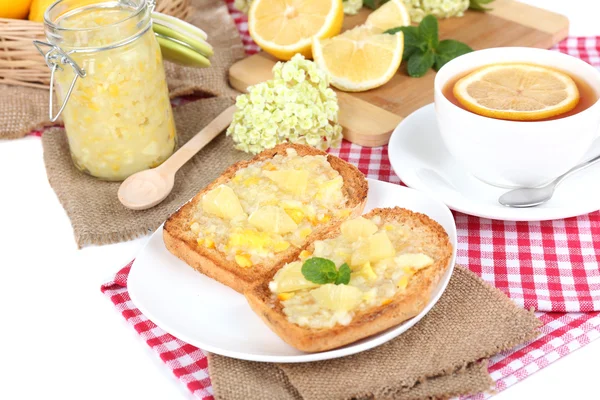 Delicious toasts with lemon jam on plate on table close-up — Stock Photo, Image