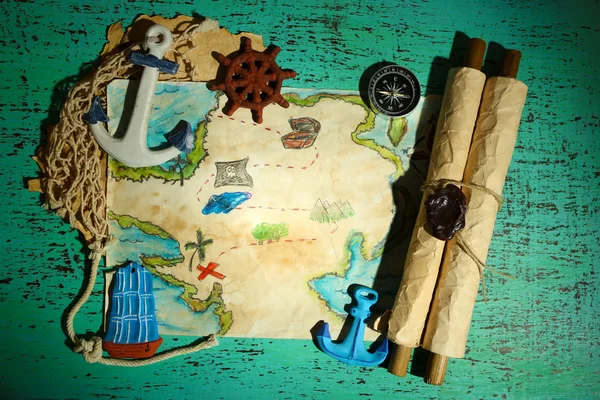 Treasure map with sea accessories, on wooden background — Stock Photo, Image
