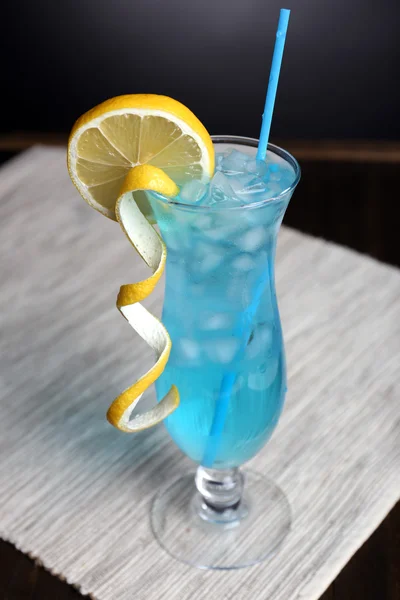 Glass of cocktail on table on grey background — Stock Photo, Image