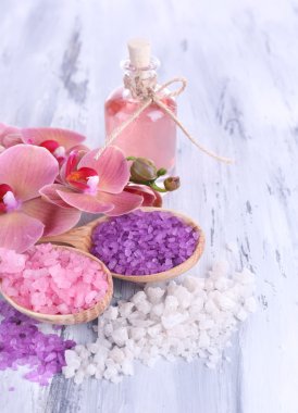 güzel çiçek ile natürmort orkide çiçek ve renk ahşap zemin üzerinde deniz tuzu ile tahta kaşıklar