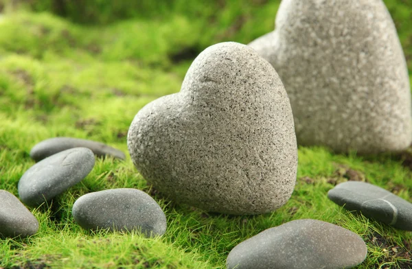 Grey stones in shape of heart, on grass background — Stock Photo, Image