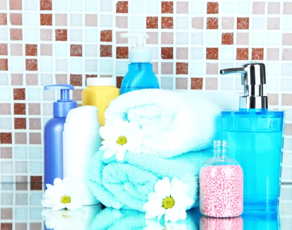 Cosmetics and bath accessories on mosaic tiles background — Stock Photo, Image