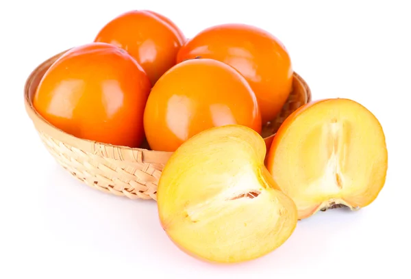 Ripe persimmons in wicker basket isolated on white — Stock Photo, Image